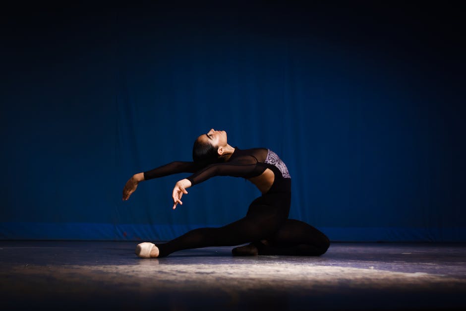 An image showcasing dancers in various ballet poses on a stage with dramatic lighting.