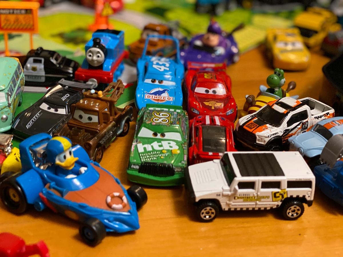 Various toy cars displayed on a shelf